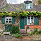 The brick house with green door and shutters